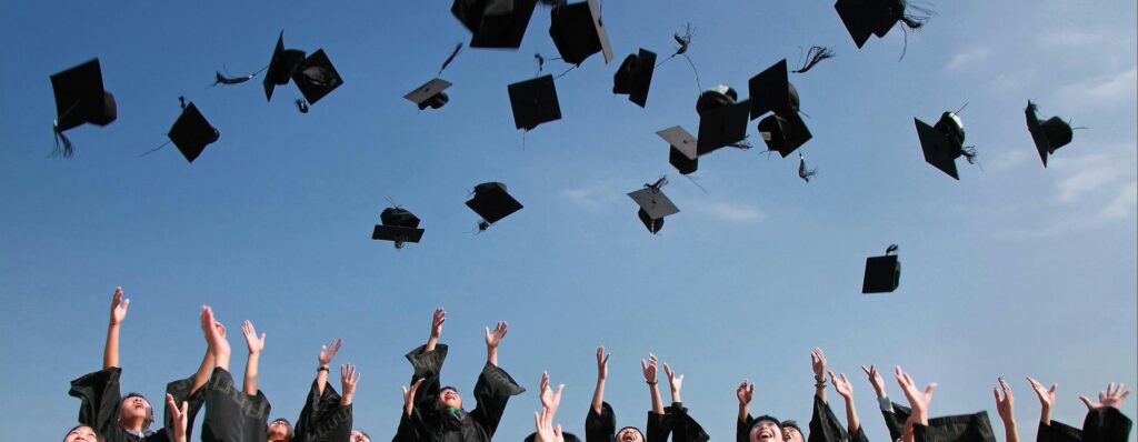 Graduating students throw caps in the air