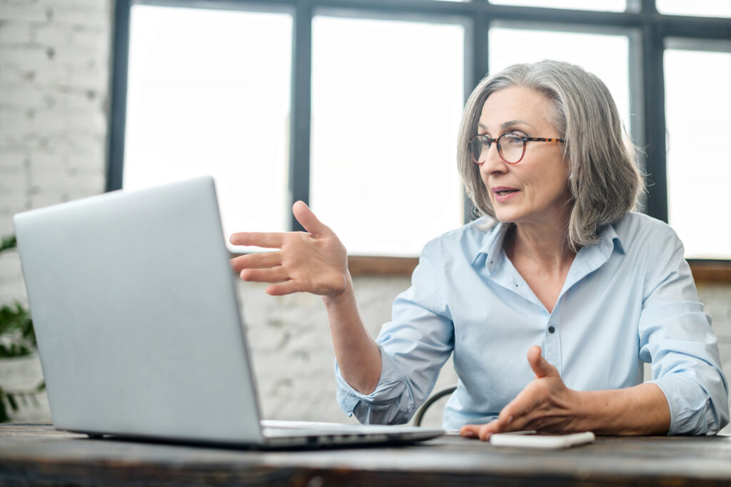 Senior professional woman looking at a computer.